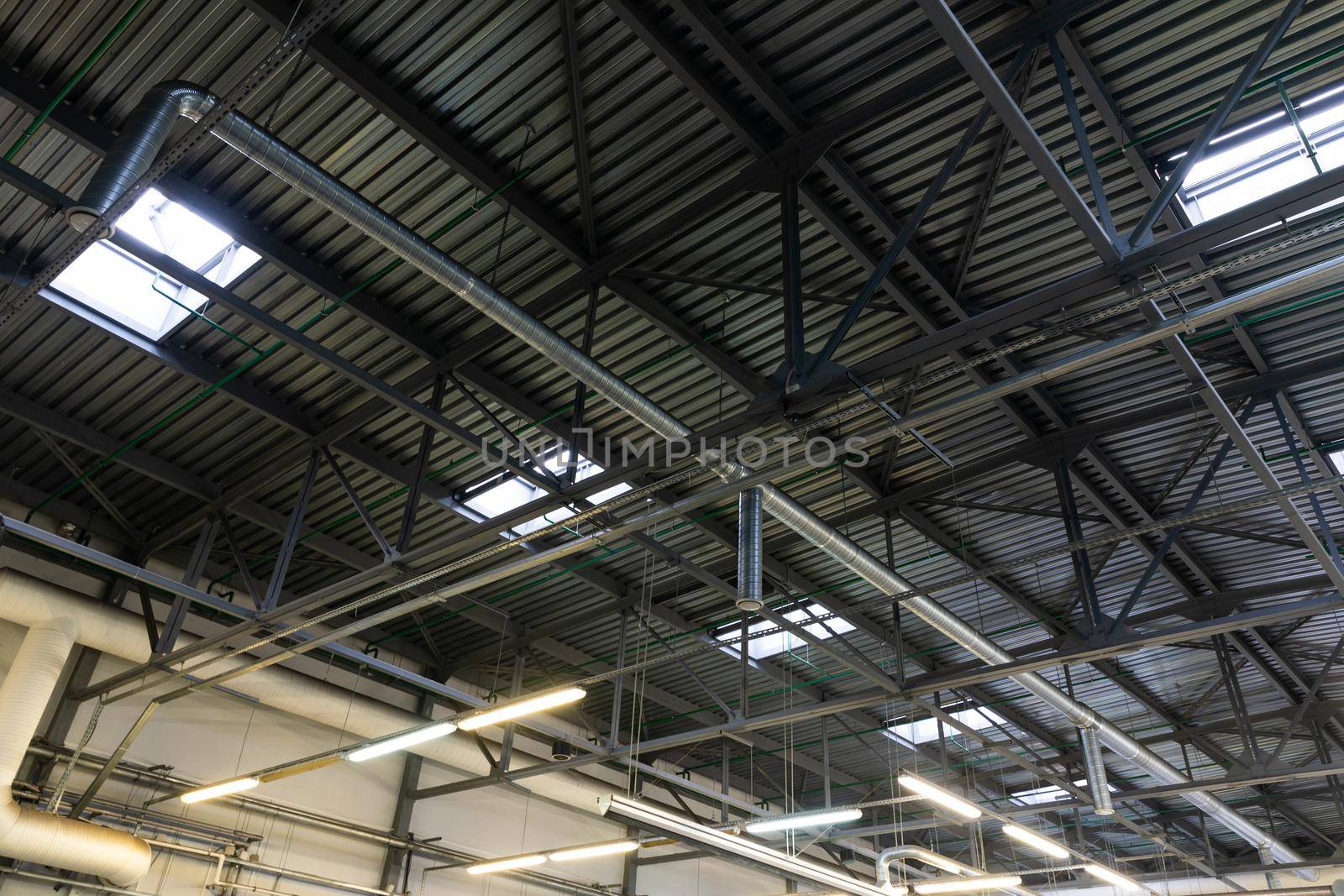 car service center ceiling with air duct system and roof glazing.