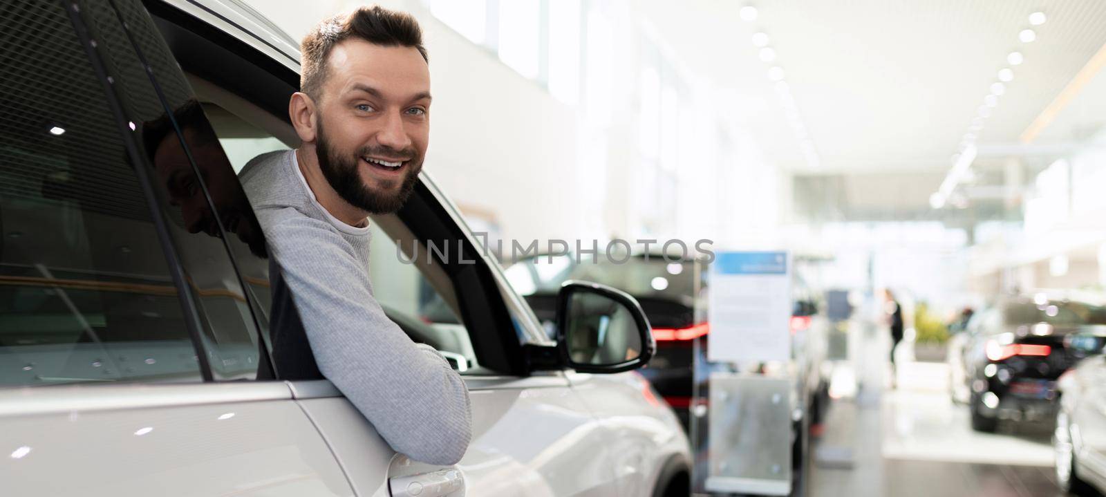 a satisfied customer purchases a new car at a dealership by TRMK