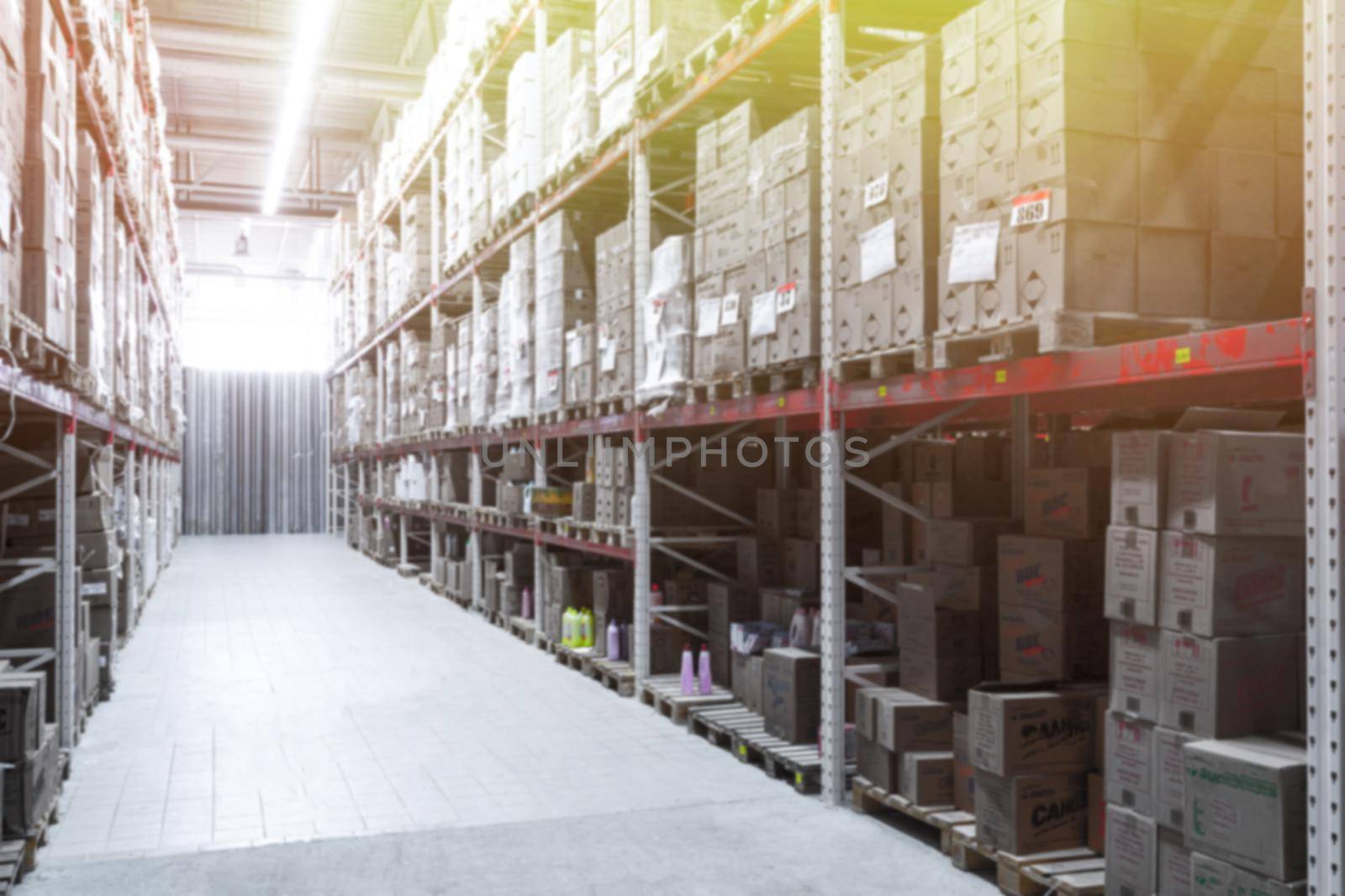 interior of a logistics center with boxes and large racks, blurred photography, defocus by TRMK