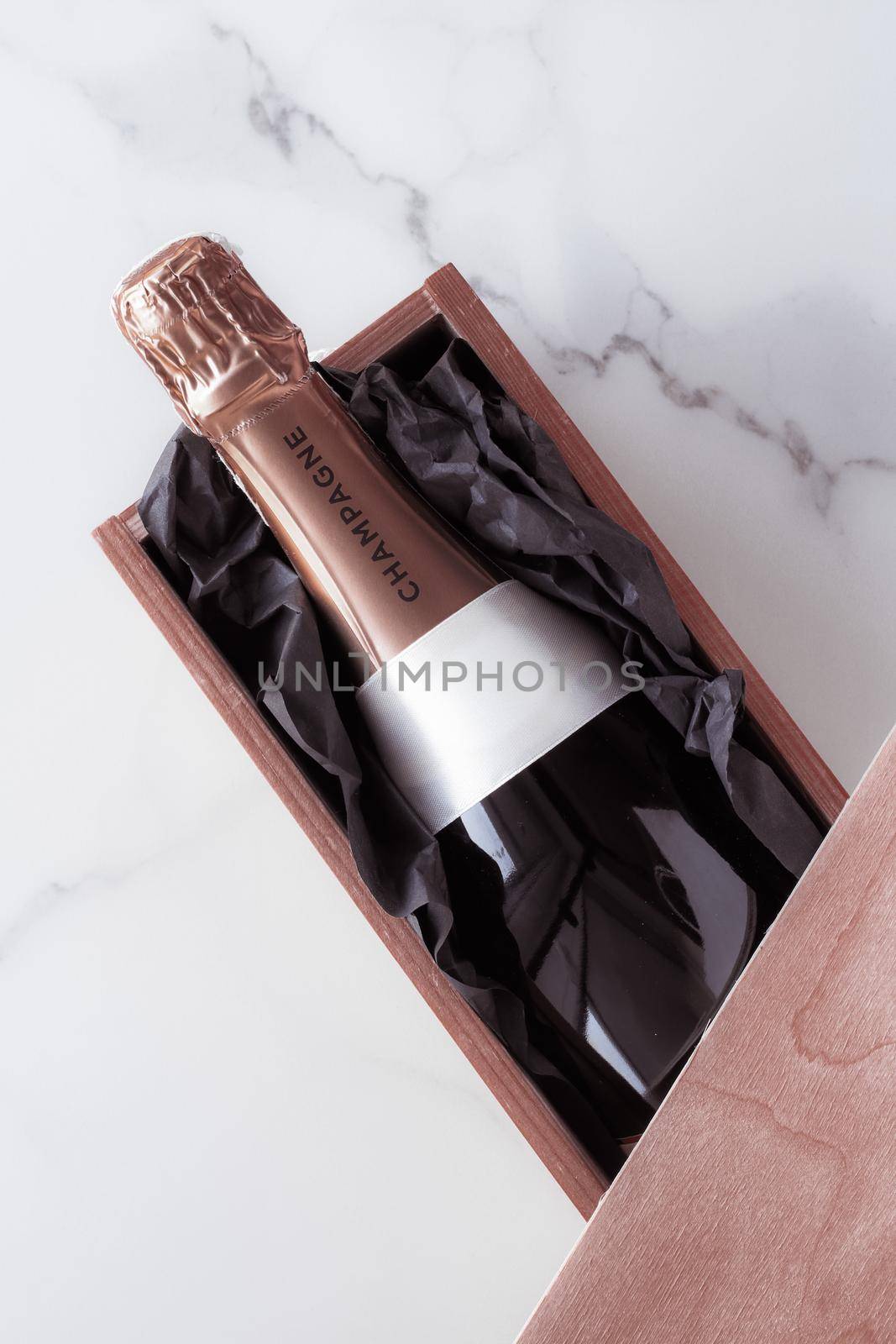 Celebration, drink and branding concept - Champagne bottle and gift box on marble, New Years, Christmas, Valentines Day or wedding holiday present and luxury product packaging for beverage brand