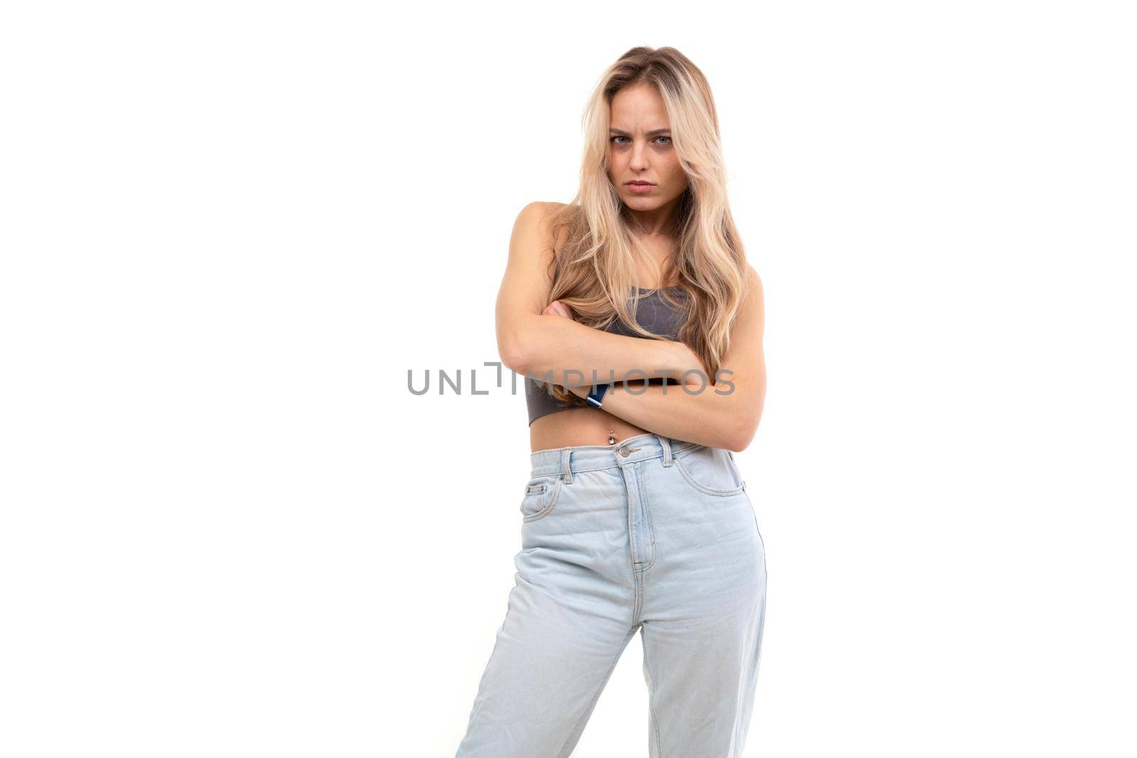 serious blonde on a white background with folded hands on her chest