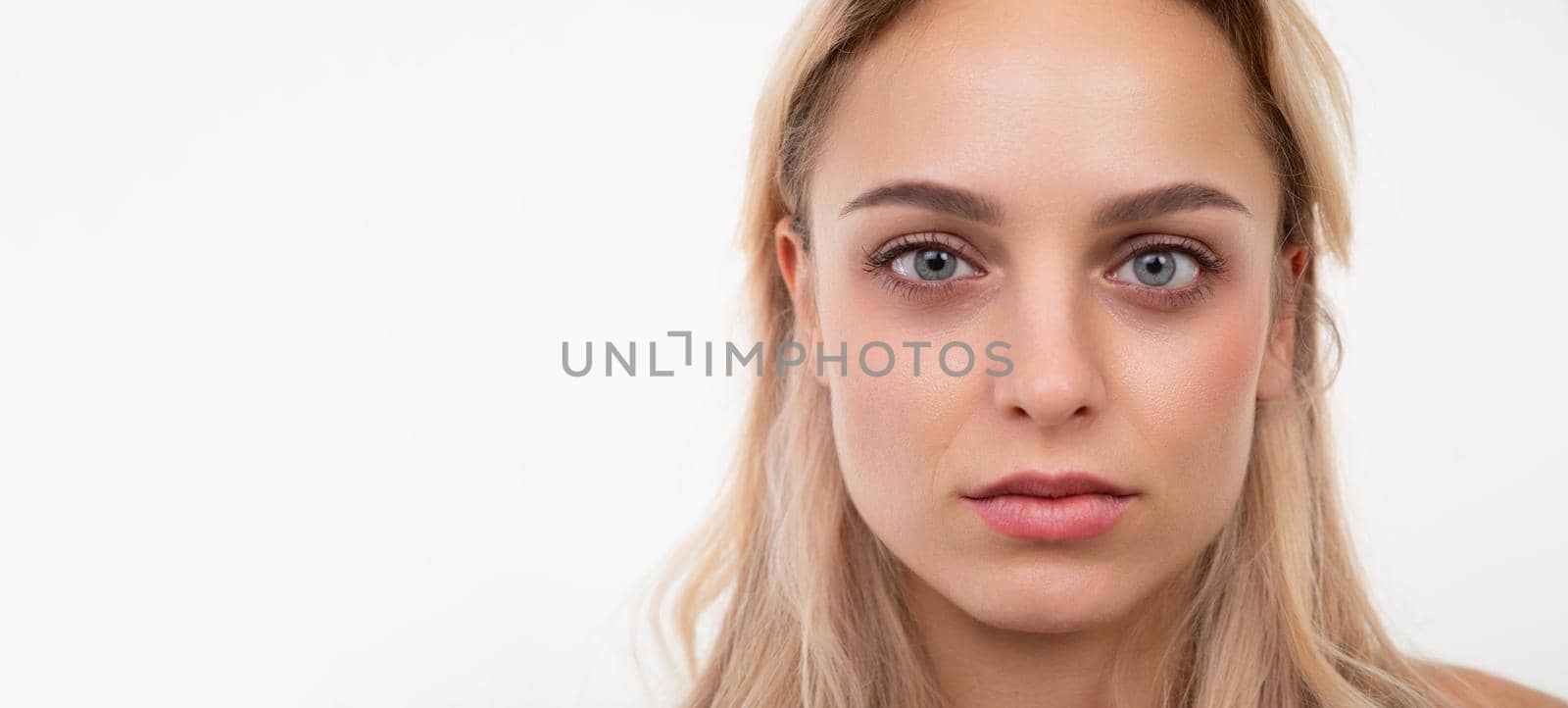 close-up portrait of a beautiful young woman with well-groomed facial skin.