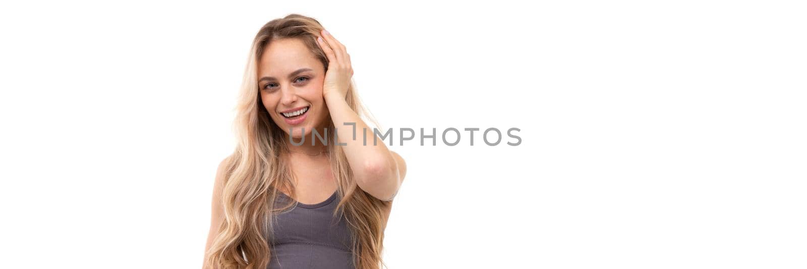 a young woman on a white background does not touch her hair with her hands by TRMK