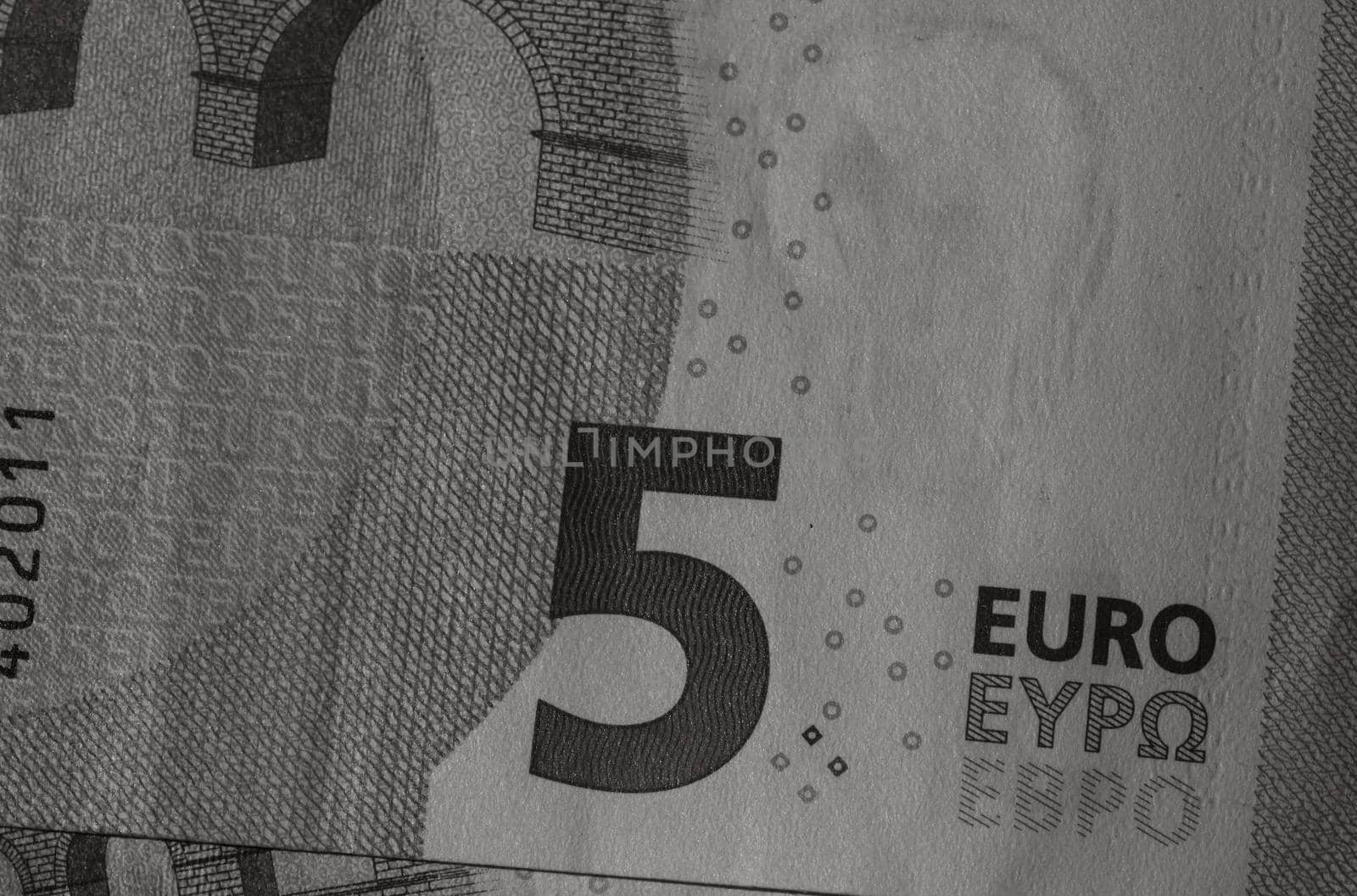 Selective focus on detail of euro banknotes. Close up macro detail of money banknotes, 5 euro isolated. World money concept, inflation and economy concept by vladispas