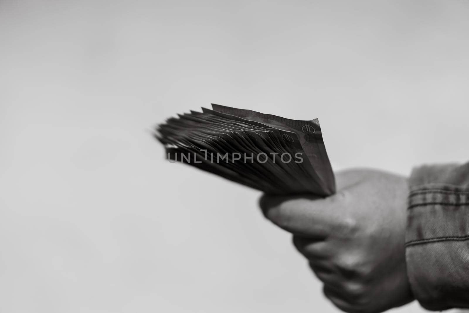 Man hand counting money for a bribe or tips. Holding EURO banknotes on a blurred background, EURO currency