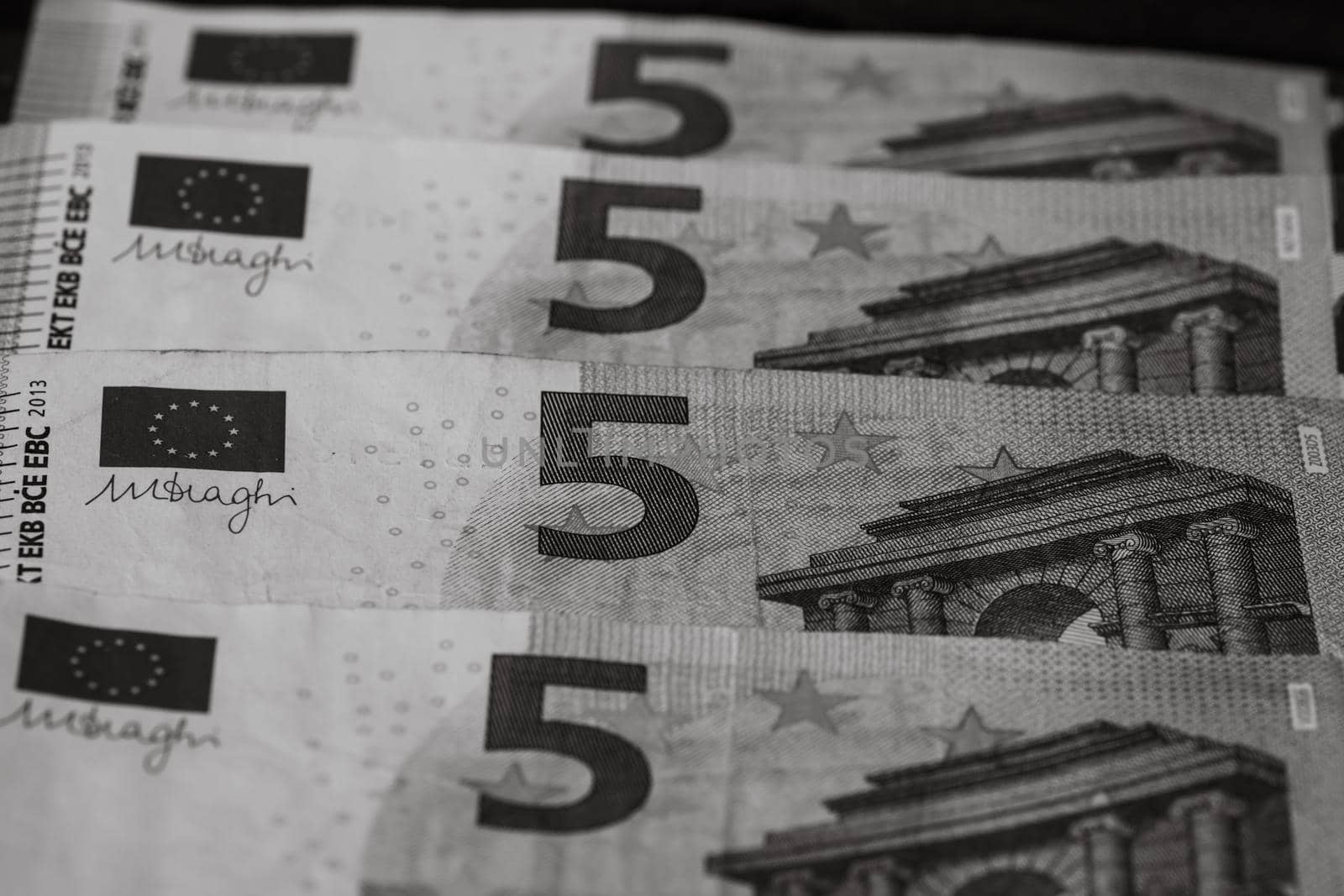 Selective focus on detail of euro banknotes. Close up macro detail of money banknotes, 5 euro isolated. World money concept, inflation and economy concept by vladispas