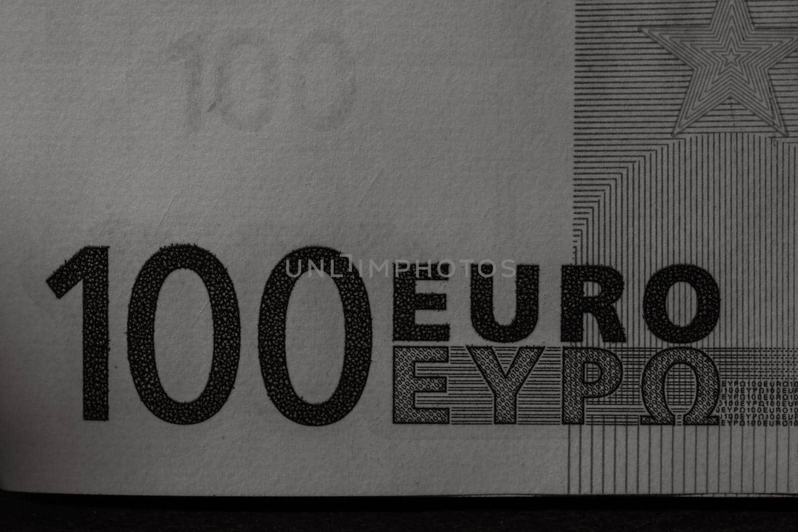 Selective focus on detail of euro banknotes. Close up macro detail of money banknotes, 100 euro isolated. World money concept, inflation and economy concept by vladispas