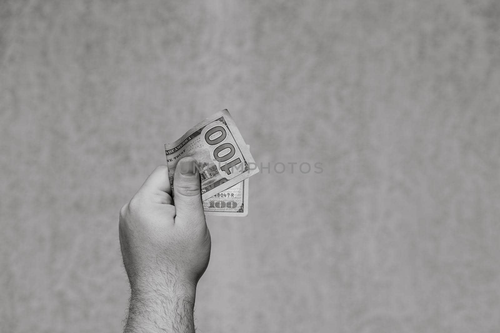 Hand holding showing dollars money and giving or receiving money like tips, salary. 100 USD banknotes, American Dollars currency isolated with copy space.