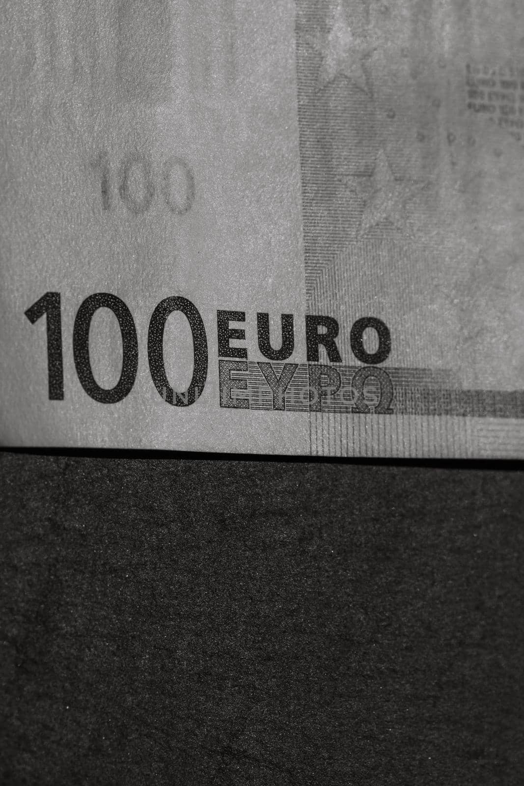 Selective focus on detail of euro banknotes. Close up macro detail of money banknotes, 100 euro isolated. World money concept, inflation and economy concept by vladispas