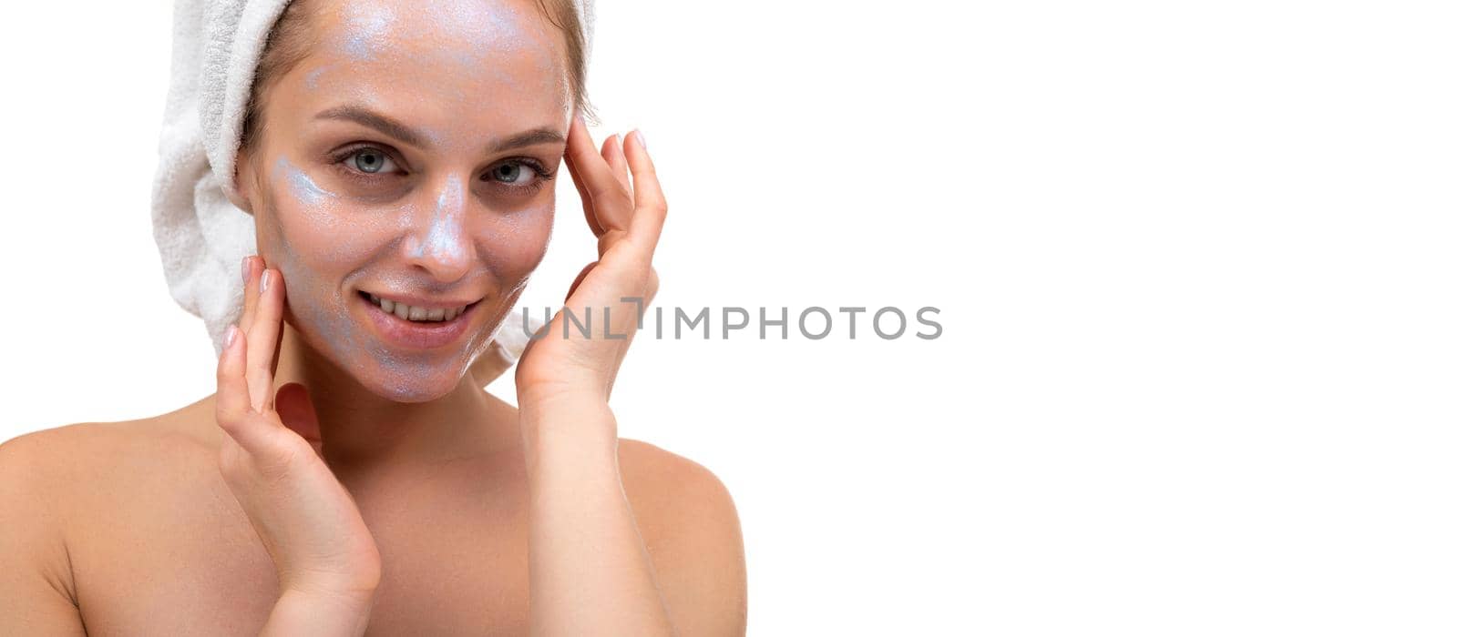 close-up portrait of a young woman with a pearl-colored cosmetic mask on her face. the concept of caring for female skin by TRMK