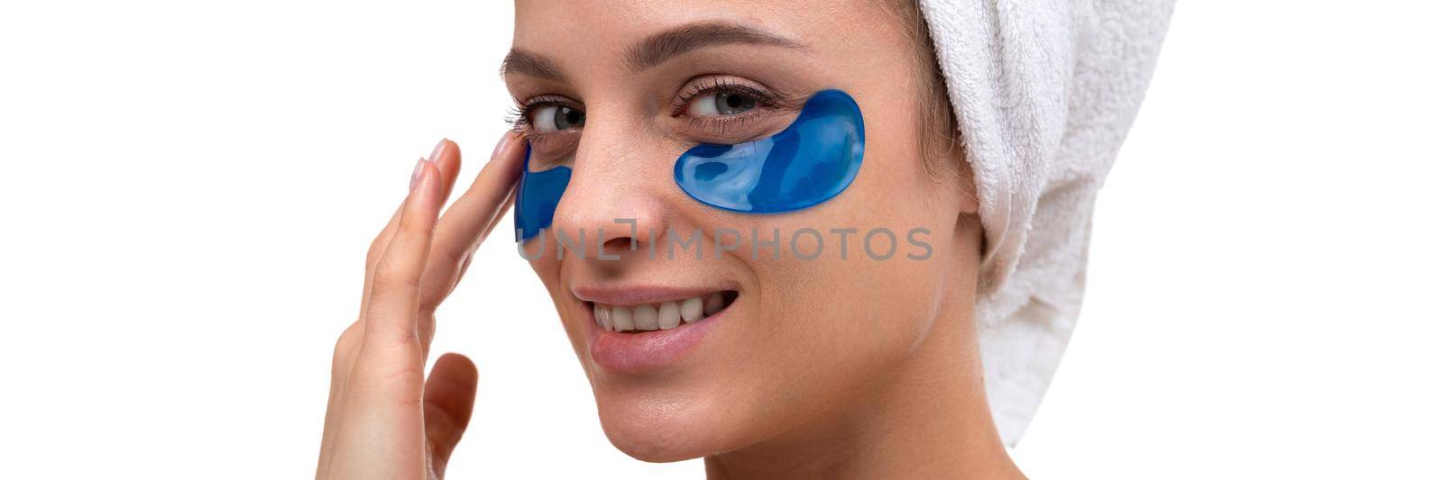 beautiful woman with blue patches on the face skin care around the eyes, cosmetic procedures.