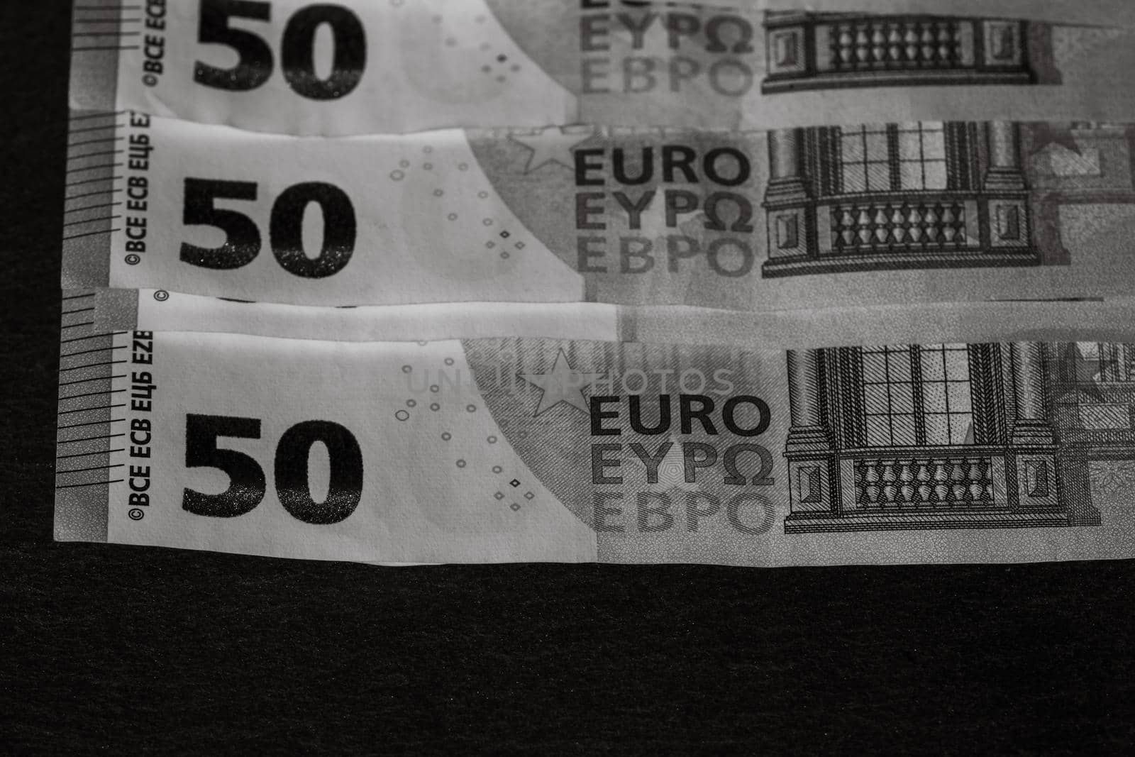 Selective focus on detail of euro banknotes. Close up macro detail of money banknotes, 50 euro isolated. World money concept, inflation and economy concept by vladispas