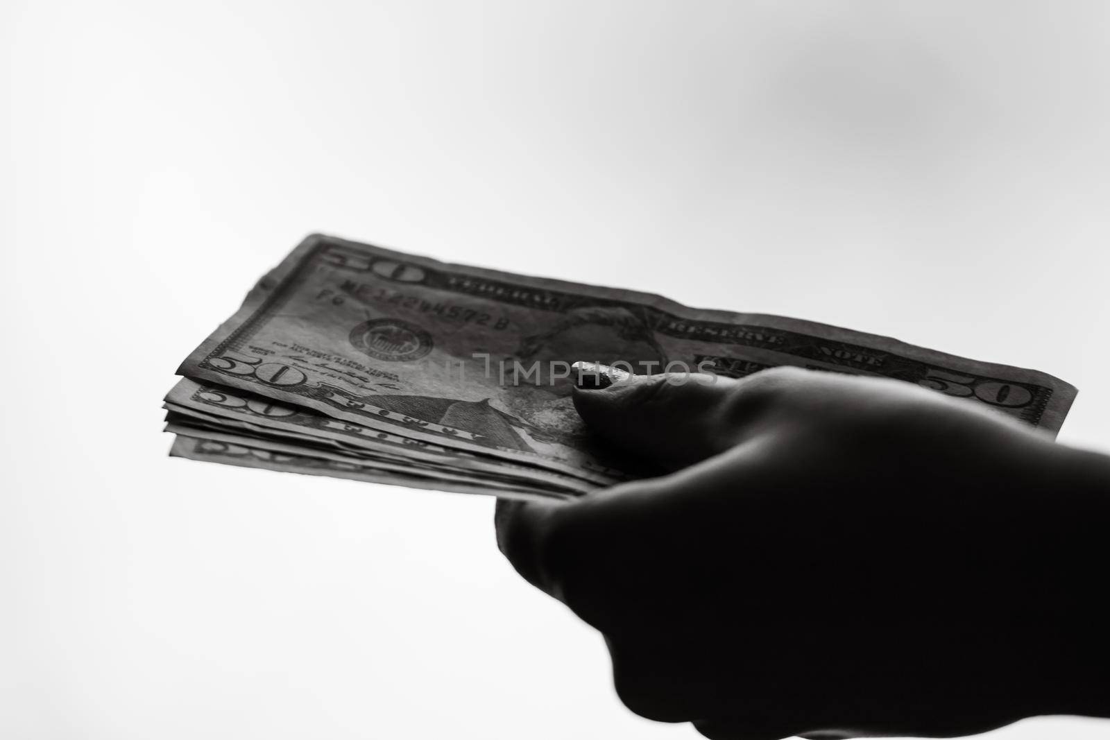 Woman hand giving money like bribe or tips isolated on white background. USD currency banknotes close up. Reward for hard work, finance and business concept