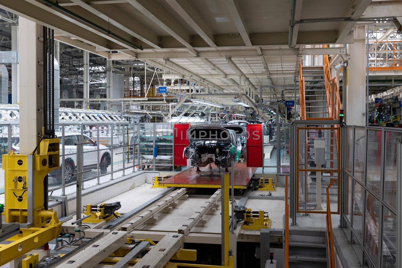 Automobile production line. Modern car assembly plant. Interior of a high-tech factory, manufacturing.