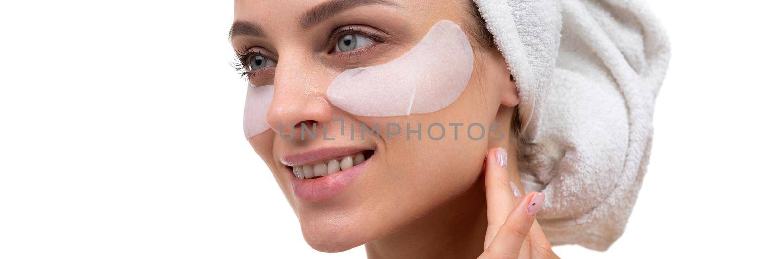 middle aged woman with cosmetic patches on her face, spa concept.