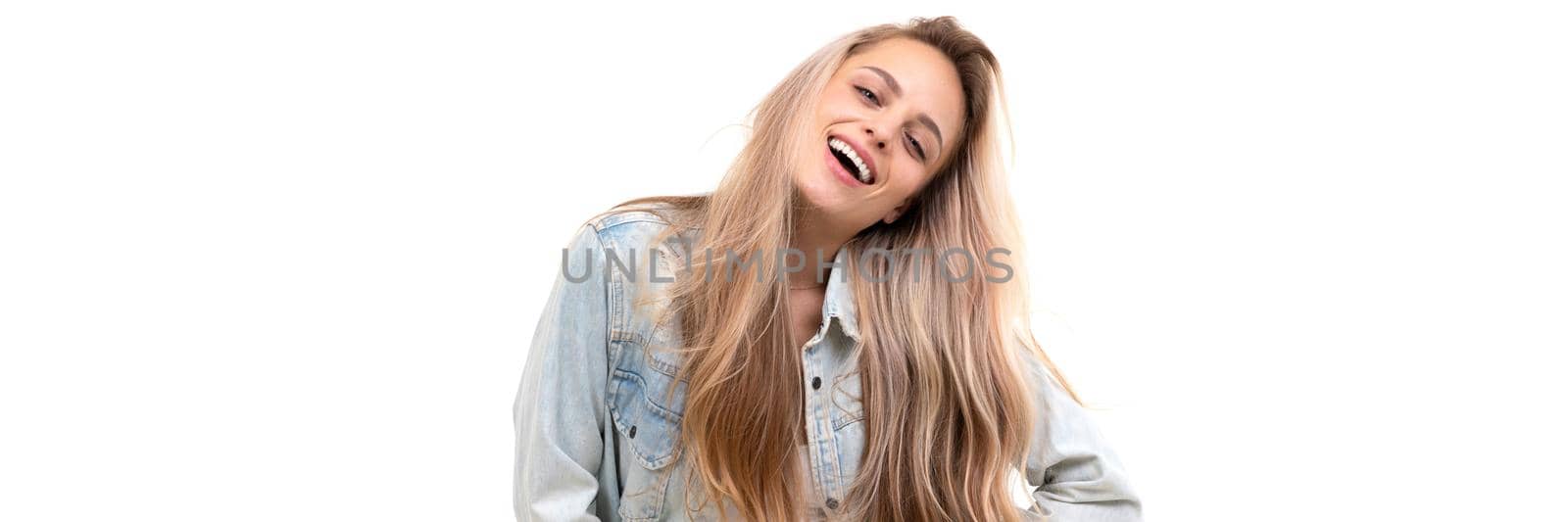 cheerful blonde on a white background in a denim light blue jacket with long hair with a smile on her face.