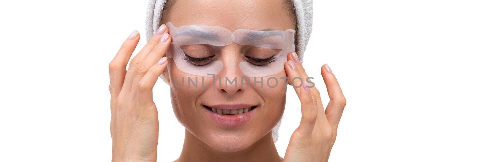 close-up of middle aged woman eye care cosmetic mask for bags under eyes.