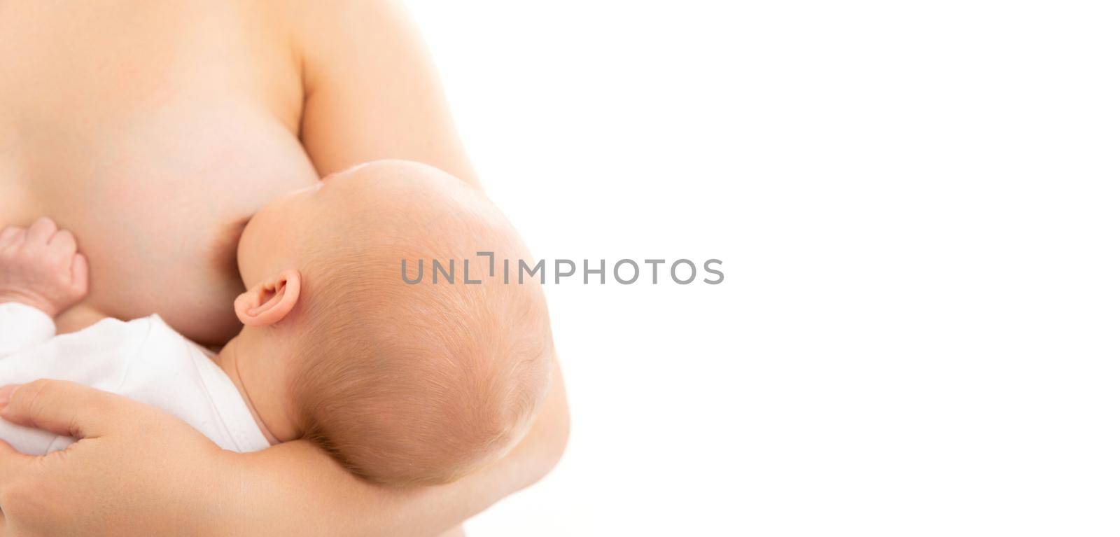 close-up of the female breast from which the child the infant drinks milk, natural feeding of the newborn.