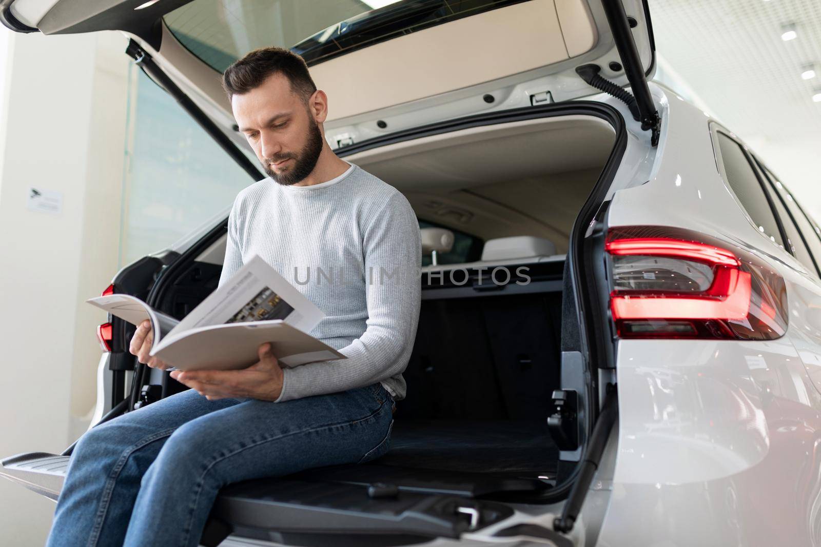 middle-aged man examines the offer of an insurance company for car insurance.