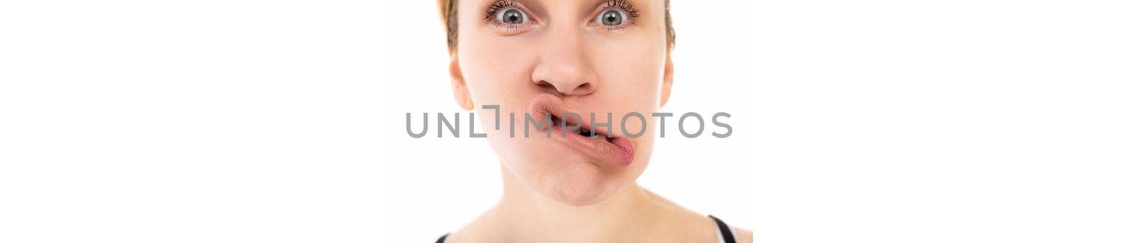 close-up portrait of a middle-aged woman with a grimace on her face.