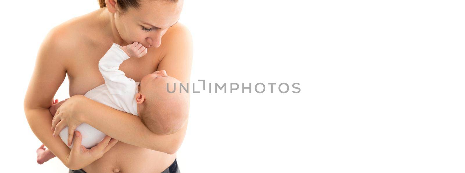 caring mother holding a newborn baby in her arms on a white background, the concept of breastfeeding with natural mother's milk.