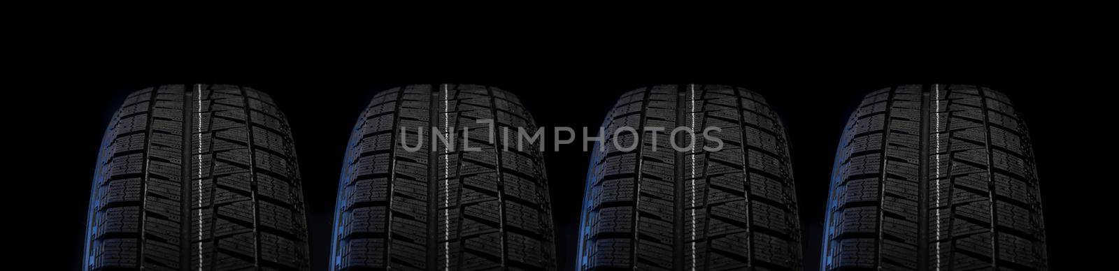 wheel with winter tread on a black background close-up by TRMK