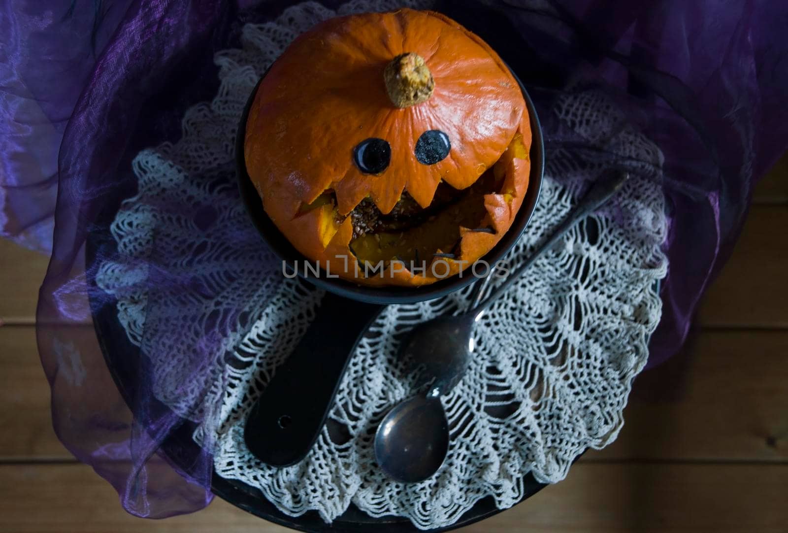 Halloween Pumpkin head, pumpkin with teeth and eyes, selective focus, vertical photo in a dark key. High quality photo