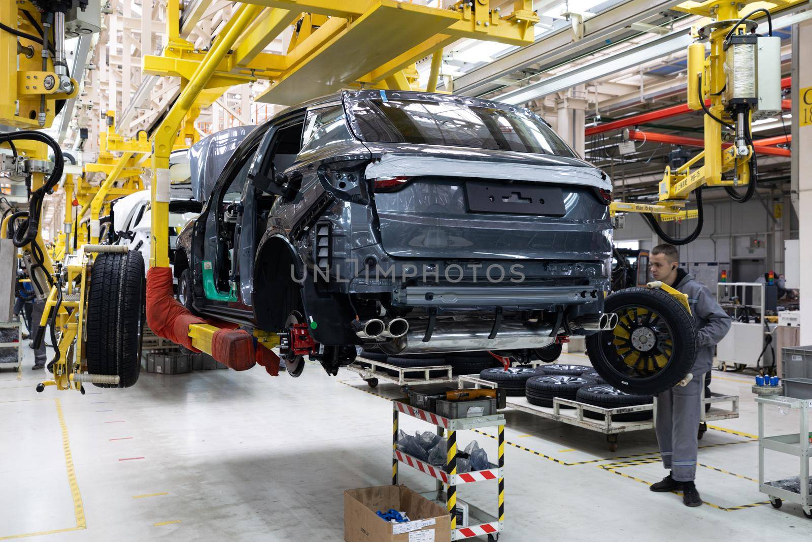 Minsk, Belarus - Dec 15, 2021: Car bodies are on assembly line. Factory for production of cars. Modern automotive industry. A car being checked before being painted in a high-tech enterprise by TRMK