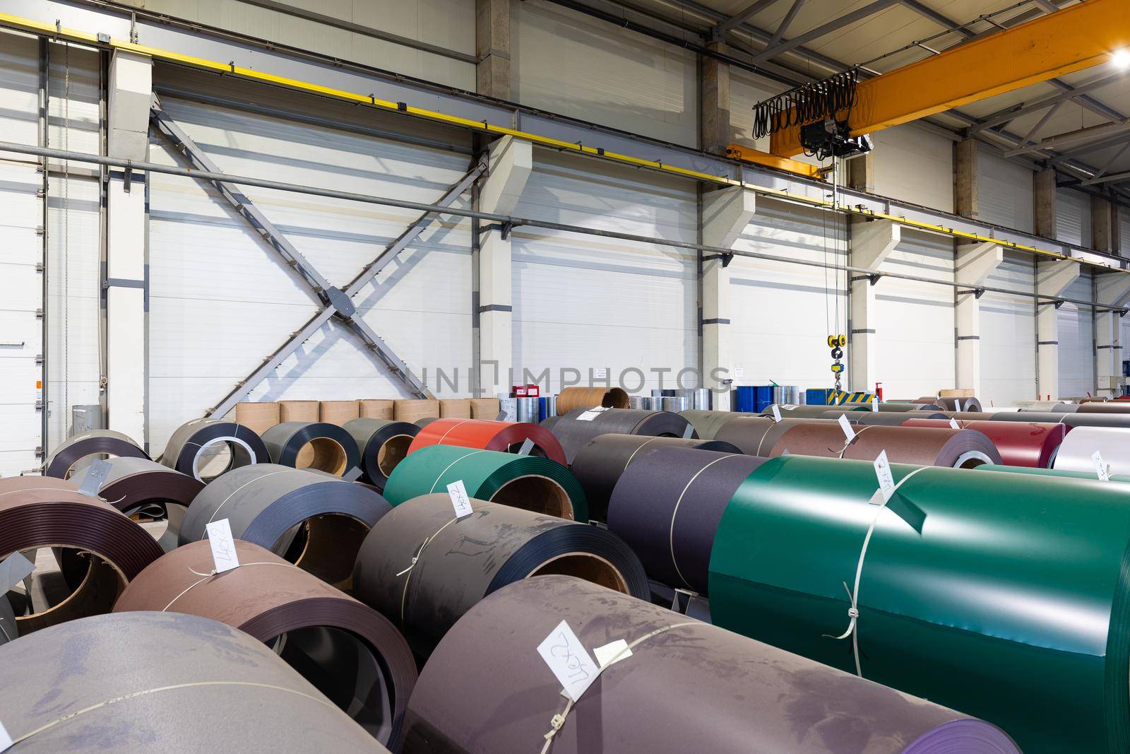 Photo shot of rolls of steel sheet stored in warehouse; Cold rolled steel coils at the factory. Engineering production.