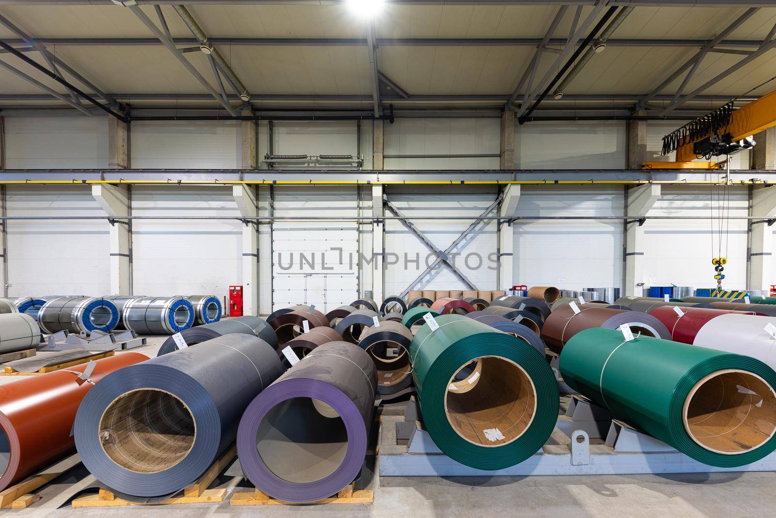 Photo shot of rolls of steel sheet stored in warehouse; Cold rolled steel coils at the factory. Engineering production by TRMK