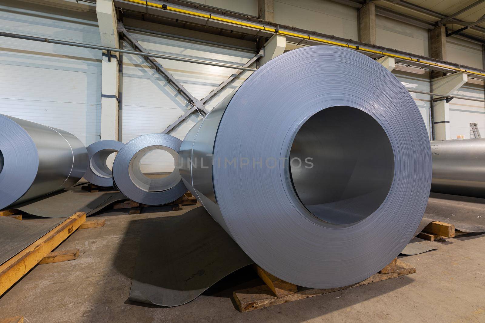 Close-up photo of metal tile for roof in metallic forming machine production line in factory. Cold rolled steel coils at the plant.