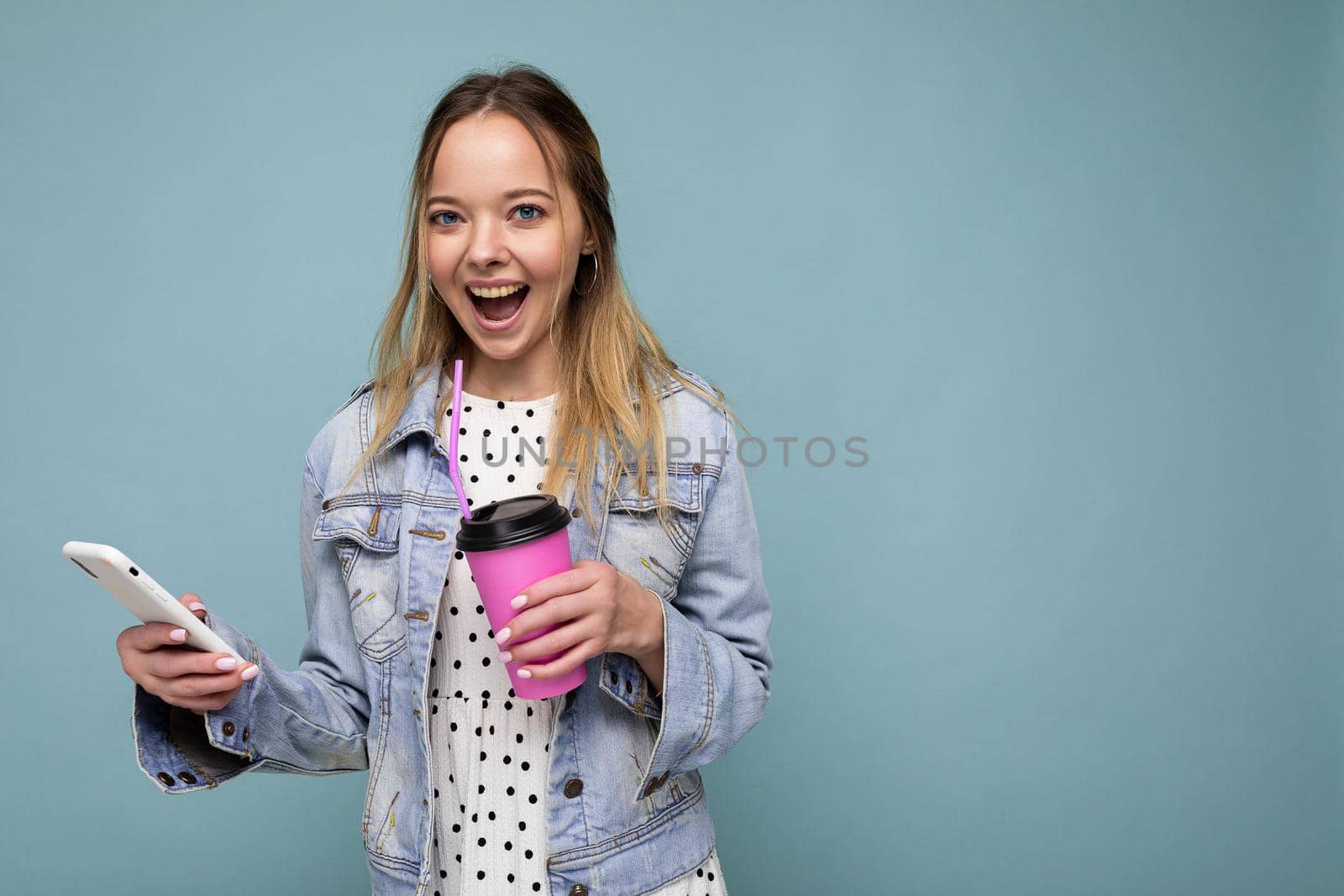 Cheerful woman laughing at message while having coffee.