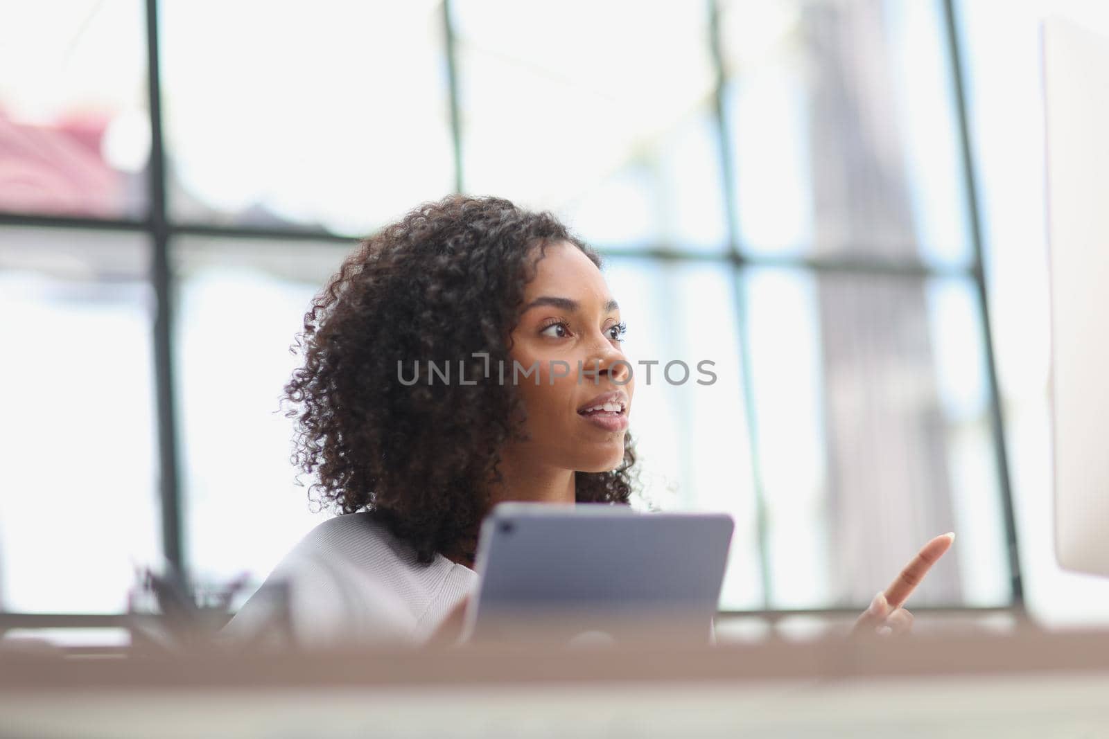 Confident businesswoman with digital tablet in office
