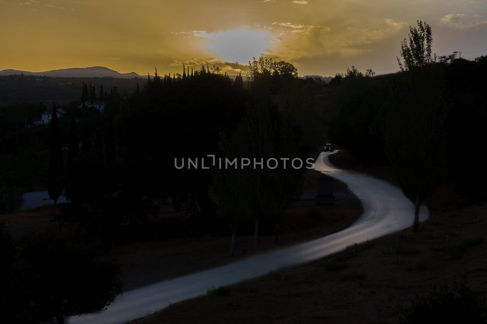 car driving on a road illuminated at dawn