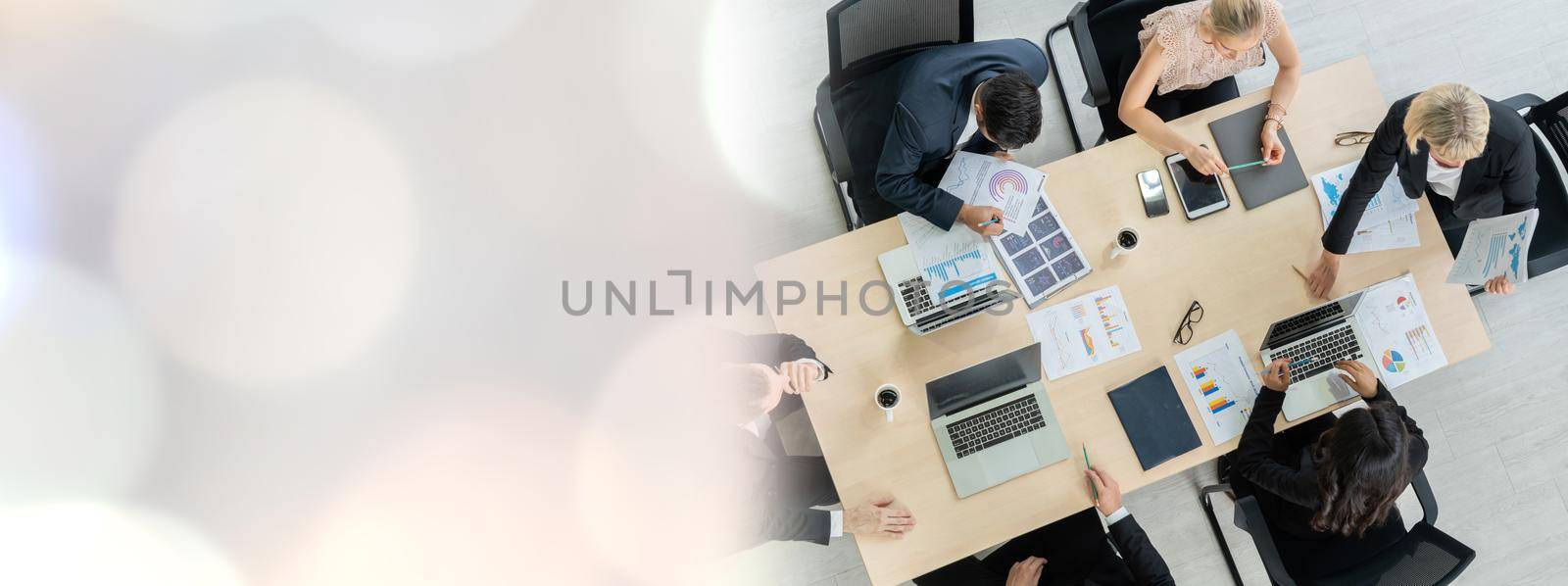 Business people group meeting shot from top widen view in office . Profession businesswomen, businessmen and office workers working in team conference with project planning document on meeting table .