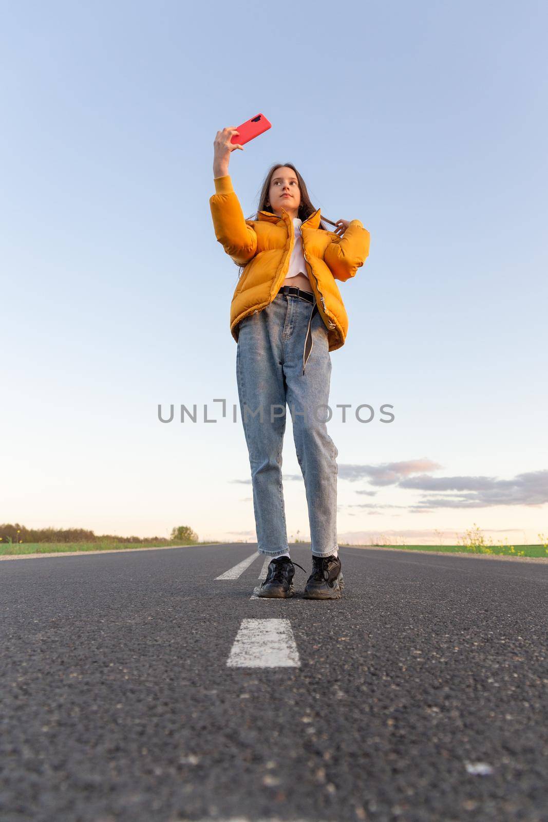 Cool modern teen girl poses on a lonely road by BY-_-BY