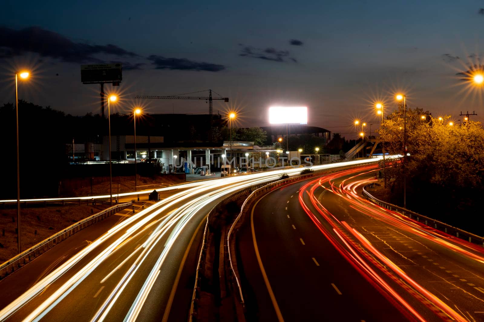 Madrid, Spain - Sep 24, 2022: Long exposure shot taken from a bridge that crosses the M-607 road in Montecarmelo looking towards Madrid. Hundreds of cars go to and from the city.