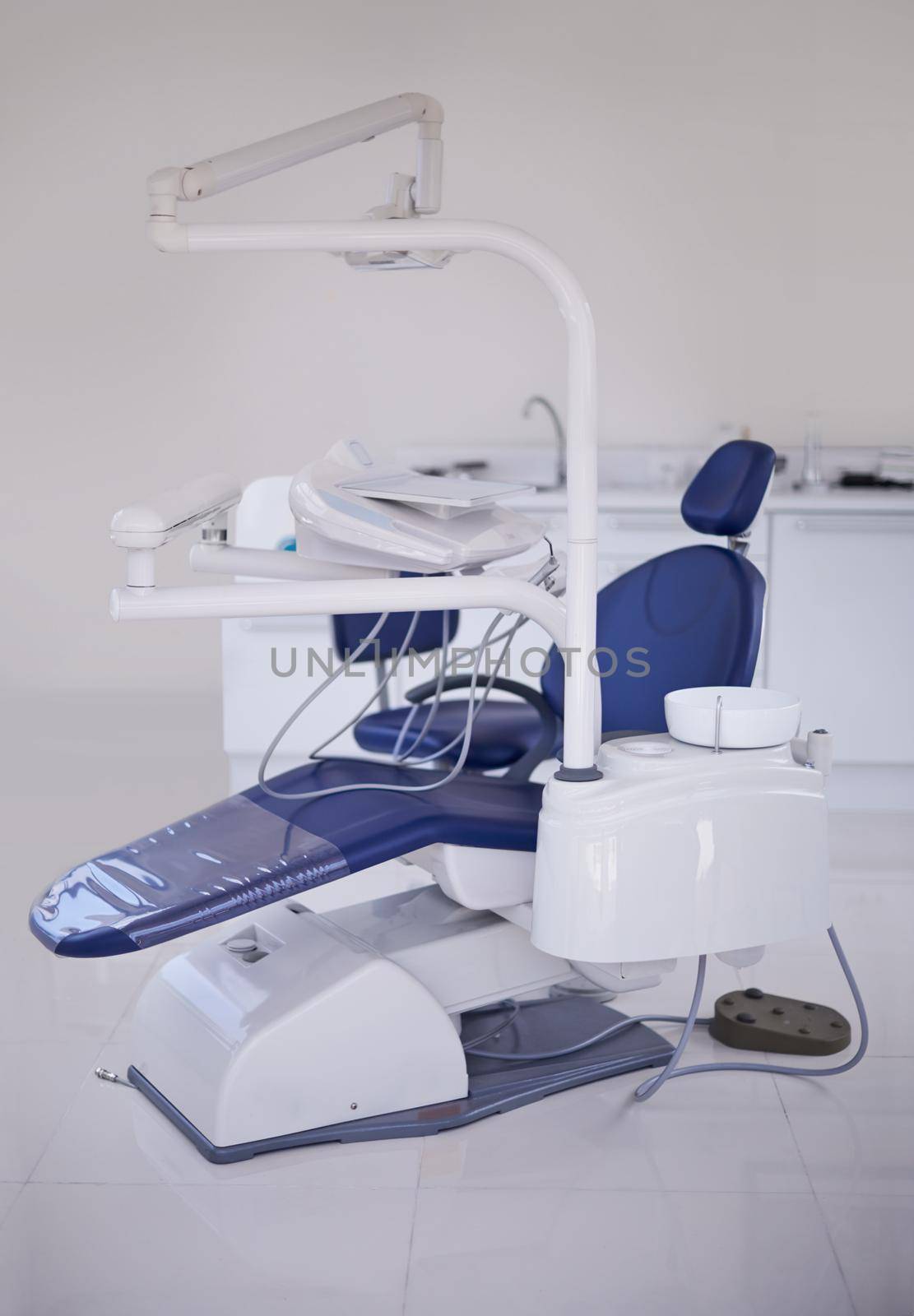 The dreaded dentists chair. A shot of a dental chair and other equipment in a dentists office. by YuriArcurs
