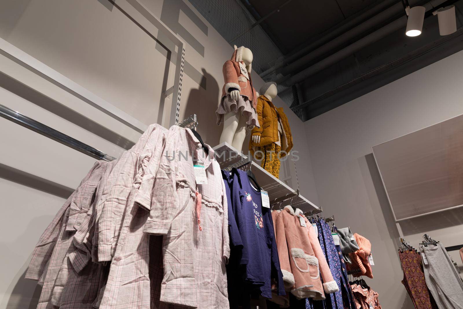 showcase with clothes in a store clothes for children and adults.