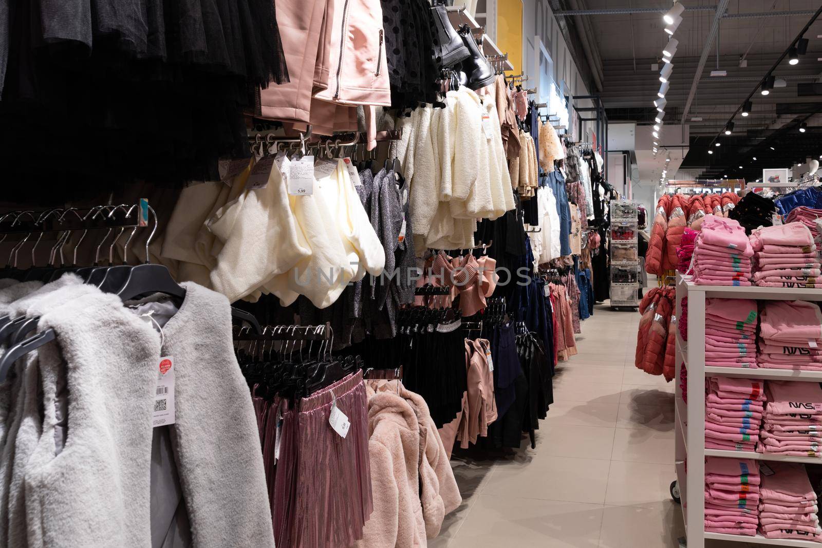interior of a boutique selling fashionable clothes for children and adults.