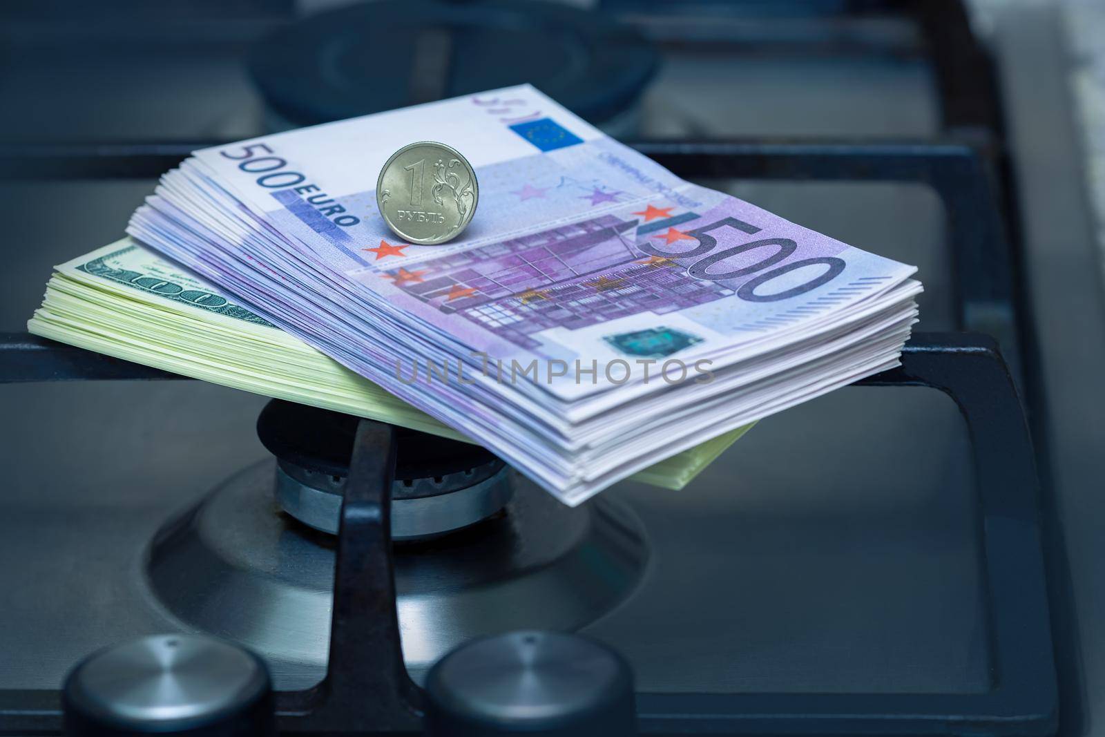 The Russian ruble stands on euro banknotes, near the gas burner of the home stove. The concept of gas payment in rubles