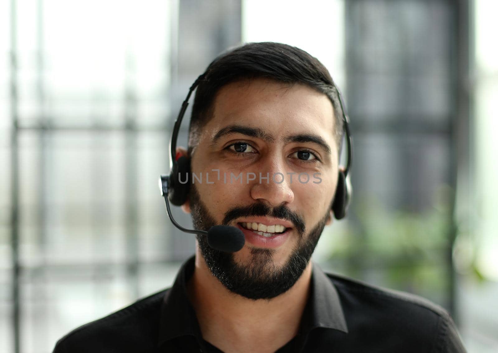 Smiling friendly handsome young male call centre operator