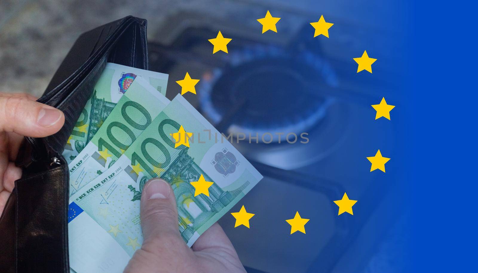 Mens hands with a purse and euro banknotes on the background of a gas stove. A concept showing the energy crisis in Europe. Rising prices and the inaccessibility of gas.