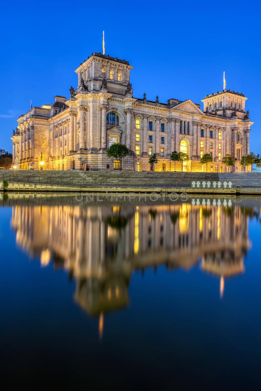The Reichstag in Berlin at night reflected in the river Spree