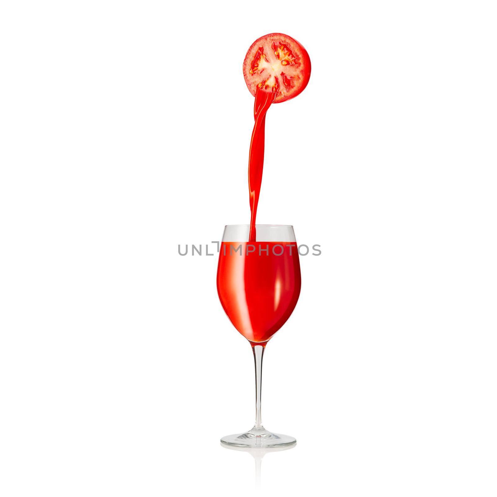 pouring tomato juice to glass isolated on white background. pouring tomato juice from fresh tomato.
