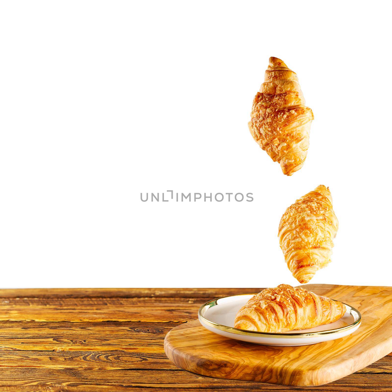 Falling fresh baked croissants with cheese. French pastry concept. Bakery pattern with baked croissant. copy space