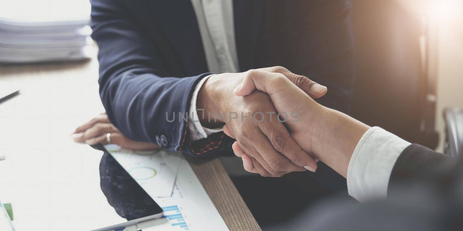 Business people shaking hands, finishing up meeting, business etiquette, congratulation, merger and acquisition concept by wichayada