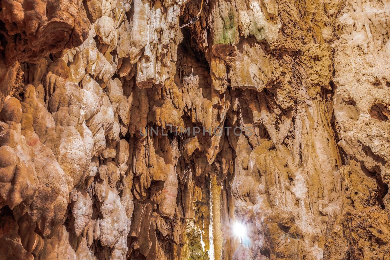 Limestone stalactites mineral formation hanging from the ceiling inside a cave in Edessa, Greece.