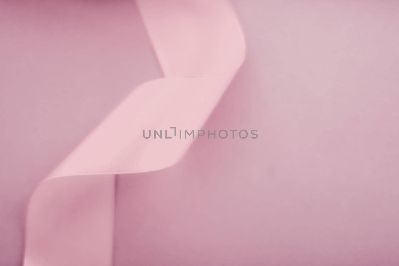 Branding, holidays and luxe brands concept - Abstract silk ribbon on blush pink background, exclusive luxury brand design for holiday sale product promotion and glamour art invitation card backdrop