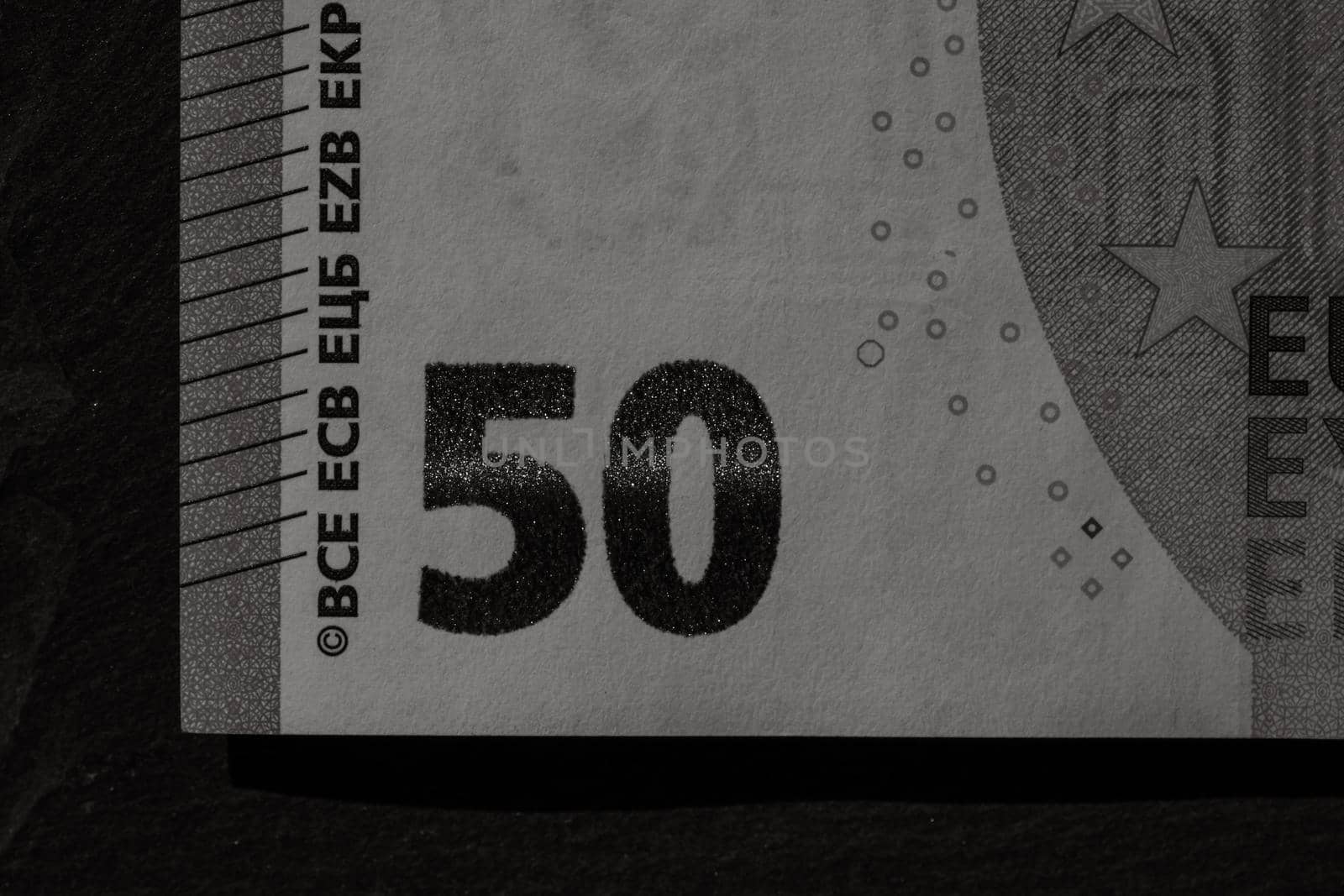 Selective focus on detail of euro banknotes. Close up macro detail of money banknotes, 50 euro isolated. World money concept, inflation and economy concept by vladispas